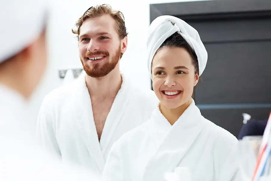 Confident adult man and woman in luxury spa robes in an elegant private treatment setting, representing discreet intimate skincare in Los Angeles County